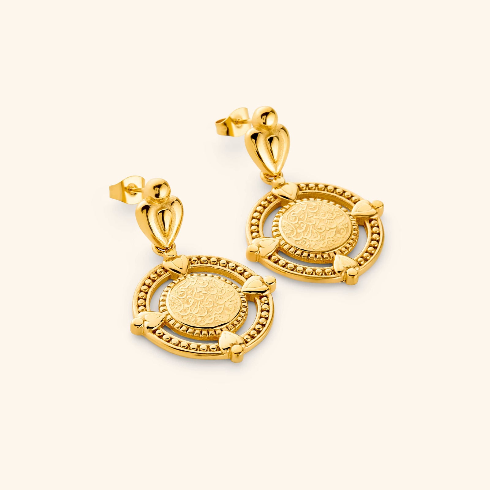 A pair of 18k gold plated dangling earrings that features the  "perhaps you dislike what's good for you" in Arabic calligraphy engraved at the center of the beaded coin. 