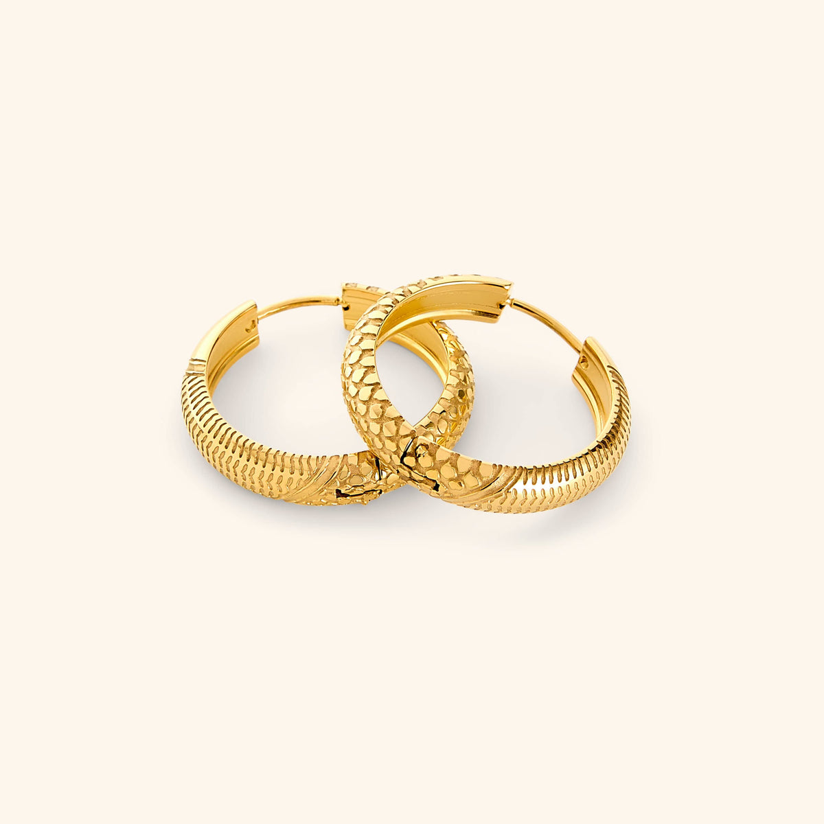 A pair of 18k gold plated hoop earrings etched with the Palestinian keffiyeh’s timeless pattern