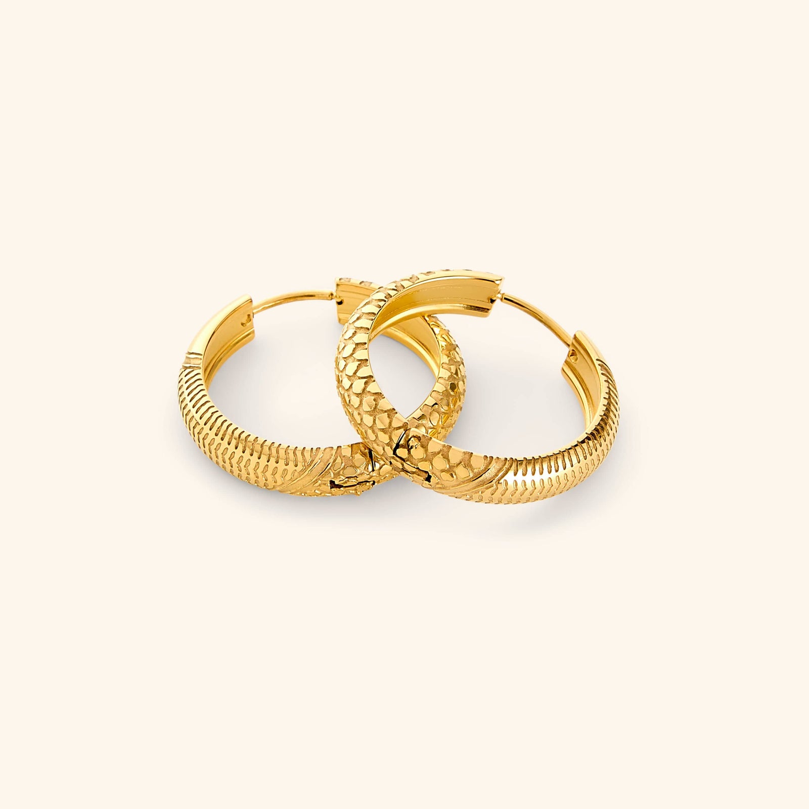 A pair of 18k gold plated hoop earrings etched with the Palestinian keffiyeh’s timeless pattern