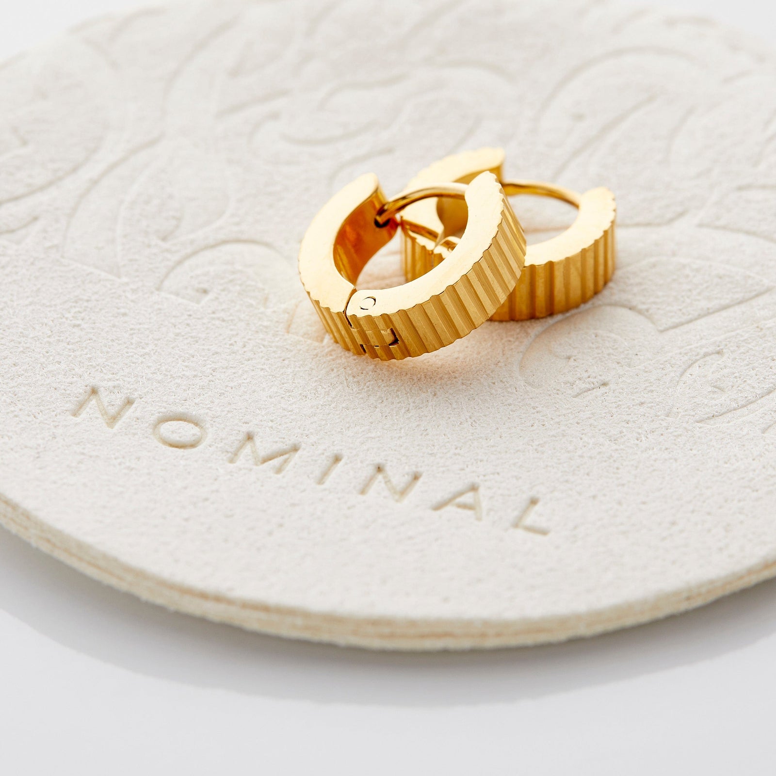 Flat lay of the gold Ridged Hoops.