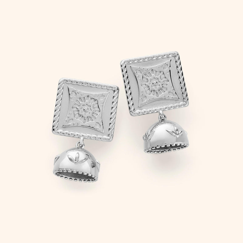 Pair of silver Square Jhumka Earrings featuring engraved square tops with floral star patterns and dangling dome-shaped jhumkas with leaf motifs pimage_ displayed on a neutral background.