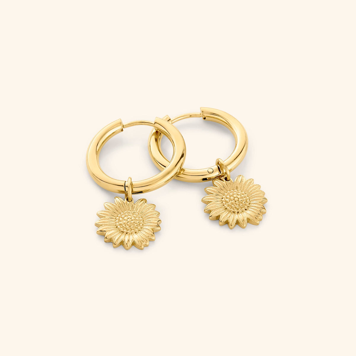 A pair of 18k gold plated earring that features sunflower shaped charm.