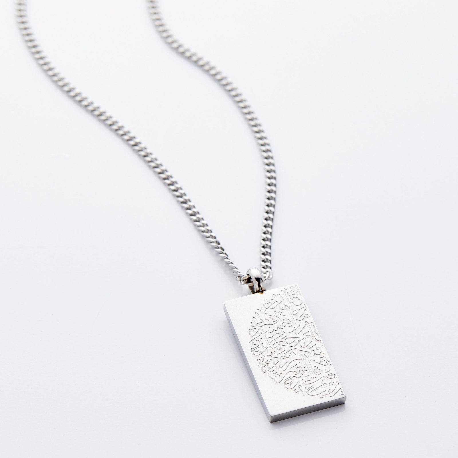 Flat lay of the silver "Tranquility in Them" Necklace against a light background.
