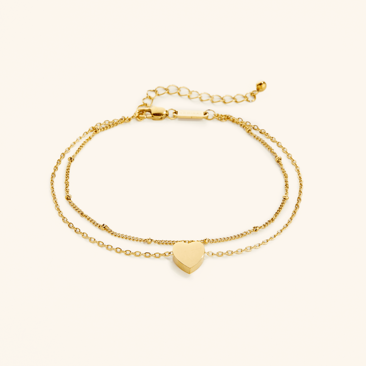 Flat lay of the 18k gold plated Dotted & Heart Stacker Anklet