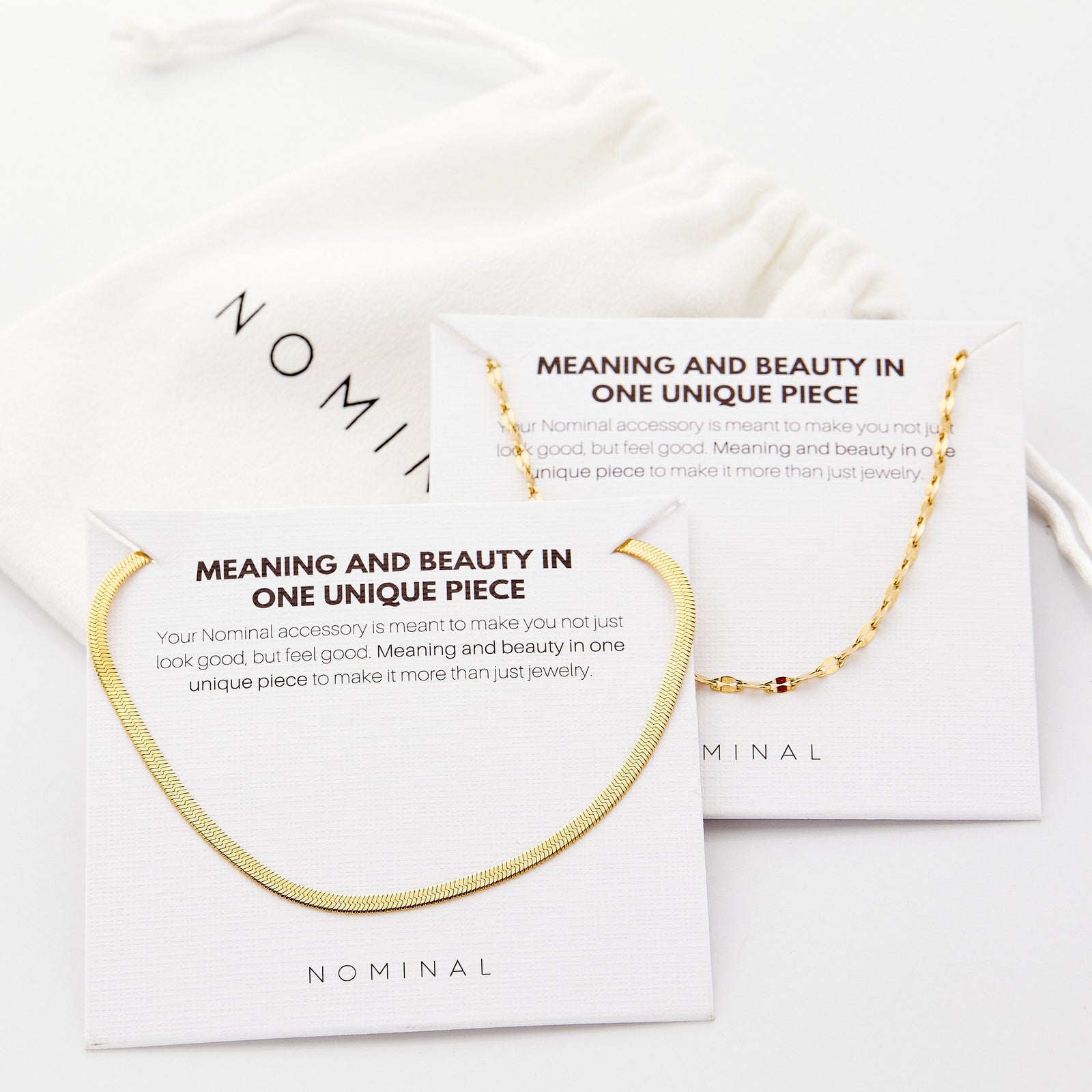 The gold Herringbone & Flutter Layering Set on its packaging that features the description for each jewelry.