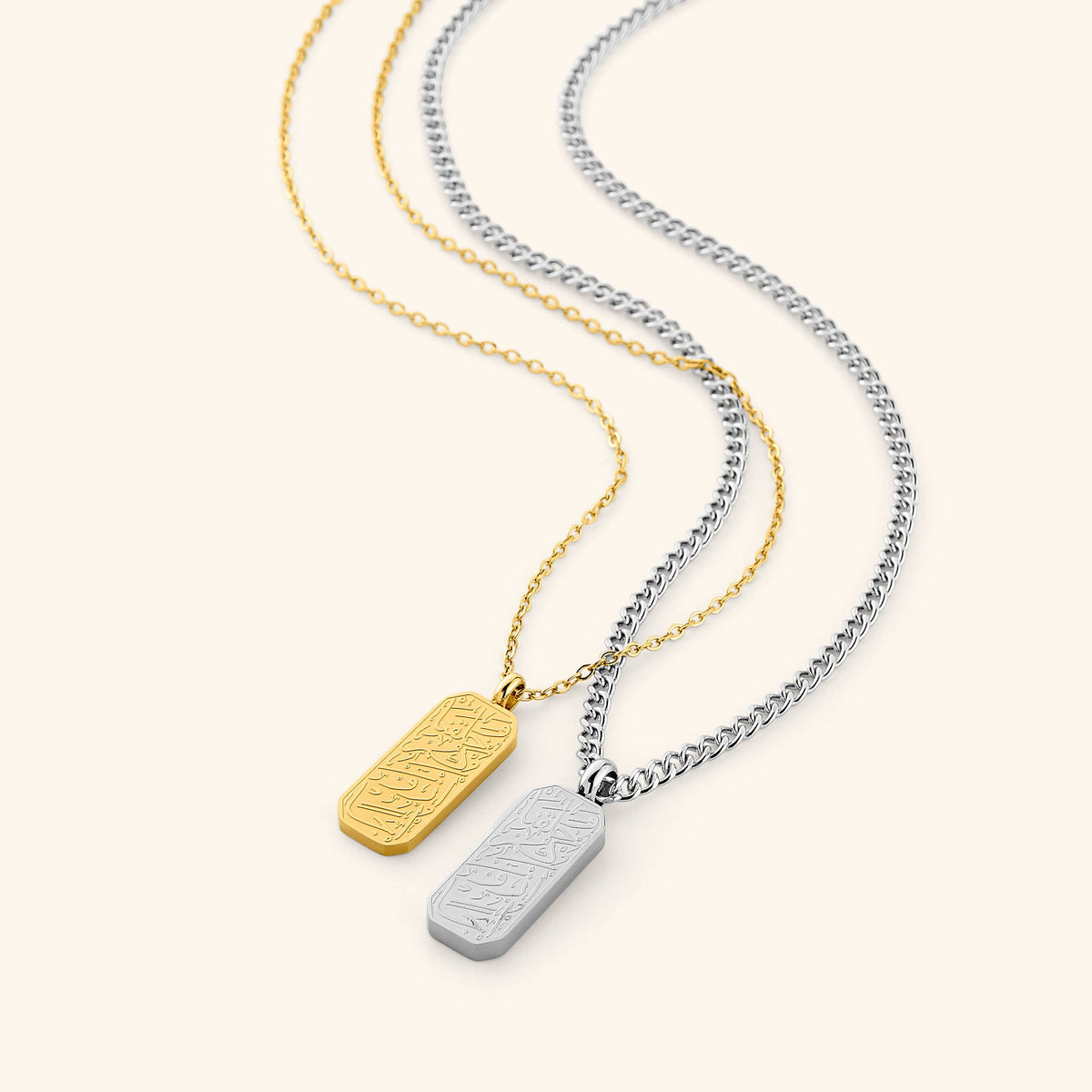 Flat lay of the His & Hers 'And We Created You In Pairs' Gift Set. Each necklace features an Arabic calligraphy engraving that translates to "And We created you in pairs."