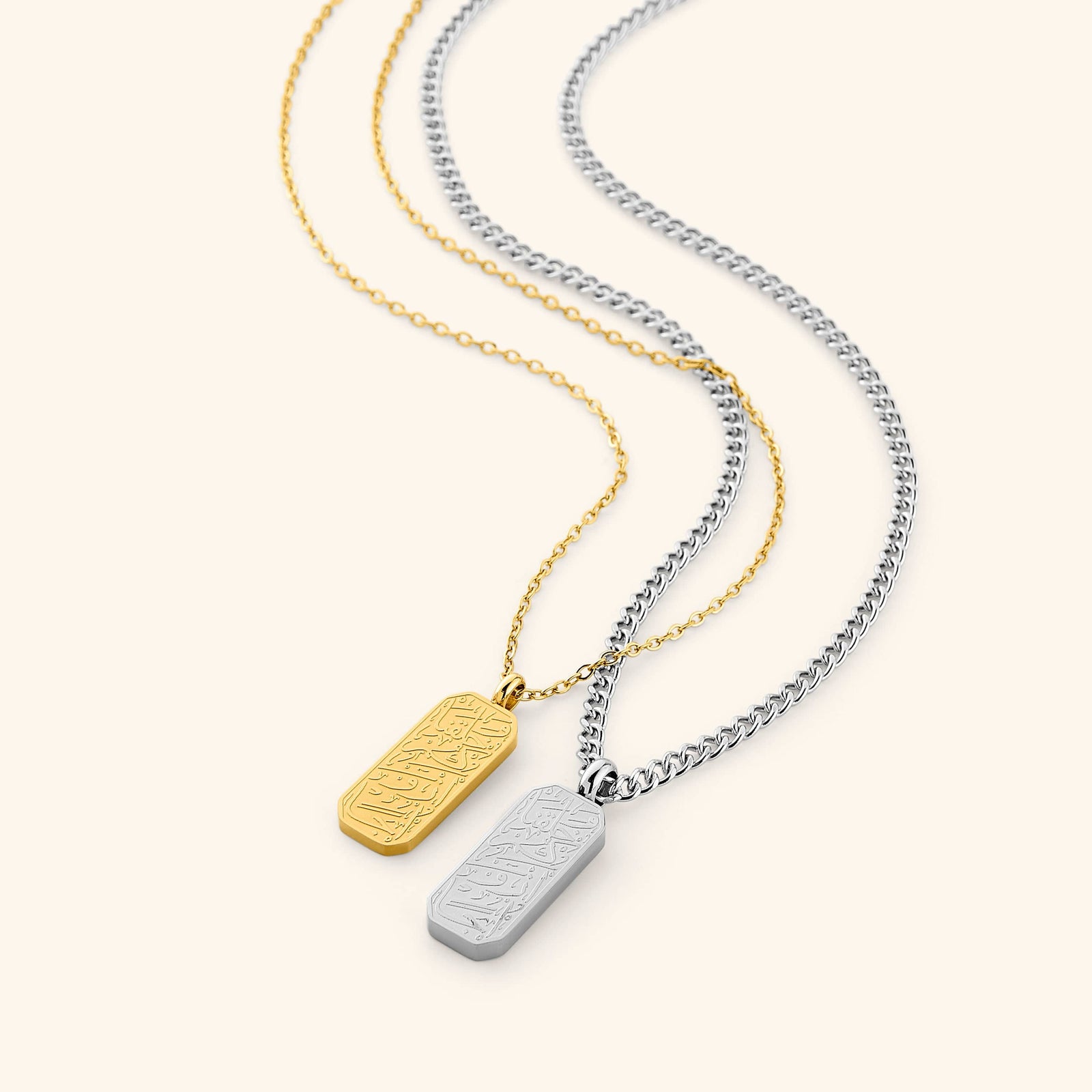 Flat lay of the His & Hers 'And We Created You In Pairs' Gift Set. Each necklace features an Arabic calligraphy engraving that translates to "And We created you in pairs."