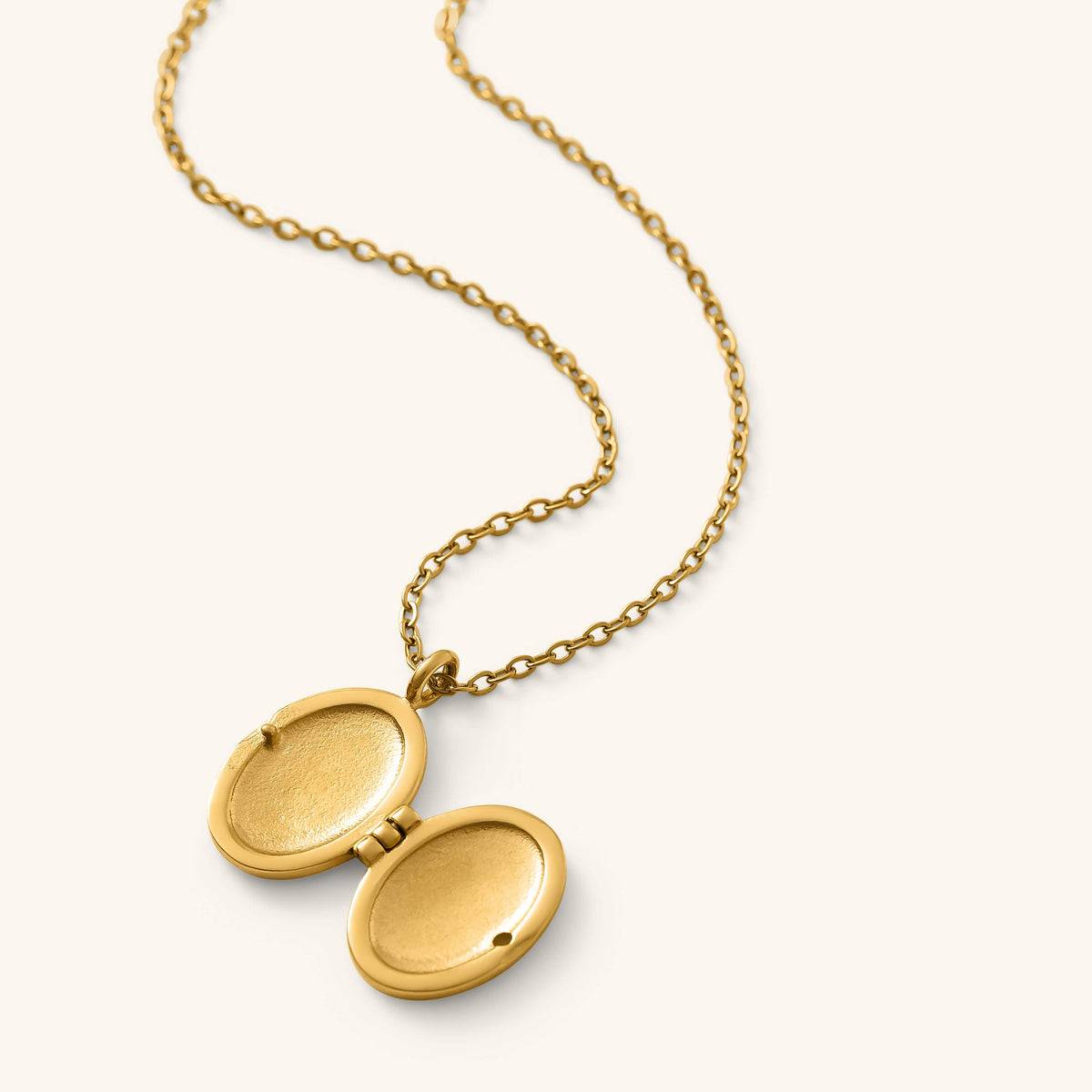 Gold Ayatul Kursi Locket shown open to reveal its interior compartments, displayed on a gold chain against a neutral background.