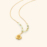 18k gold plated chain necklace with a poppy flower pendant and pale green tube beads.