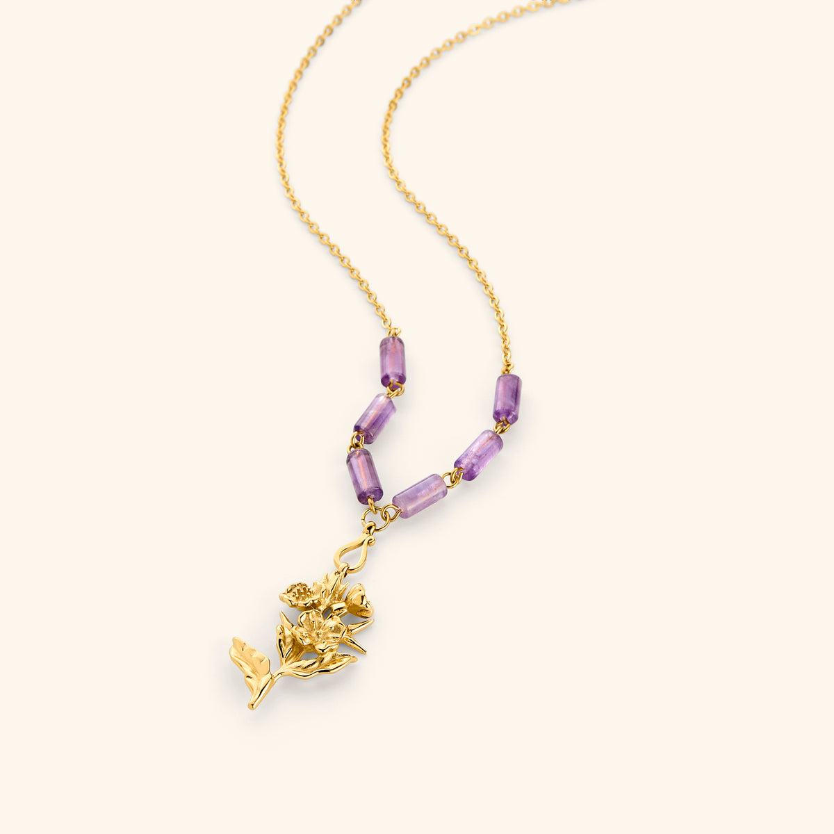 18k gold plated chain necklace with a detailed flower stem pendant and purple tube beads.