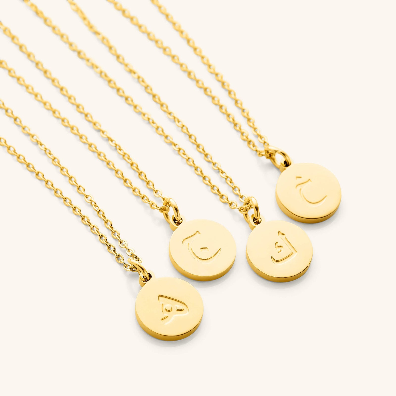 Photo of a set of Arabic Letter Necklace with different letters on each pendant.
