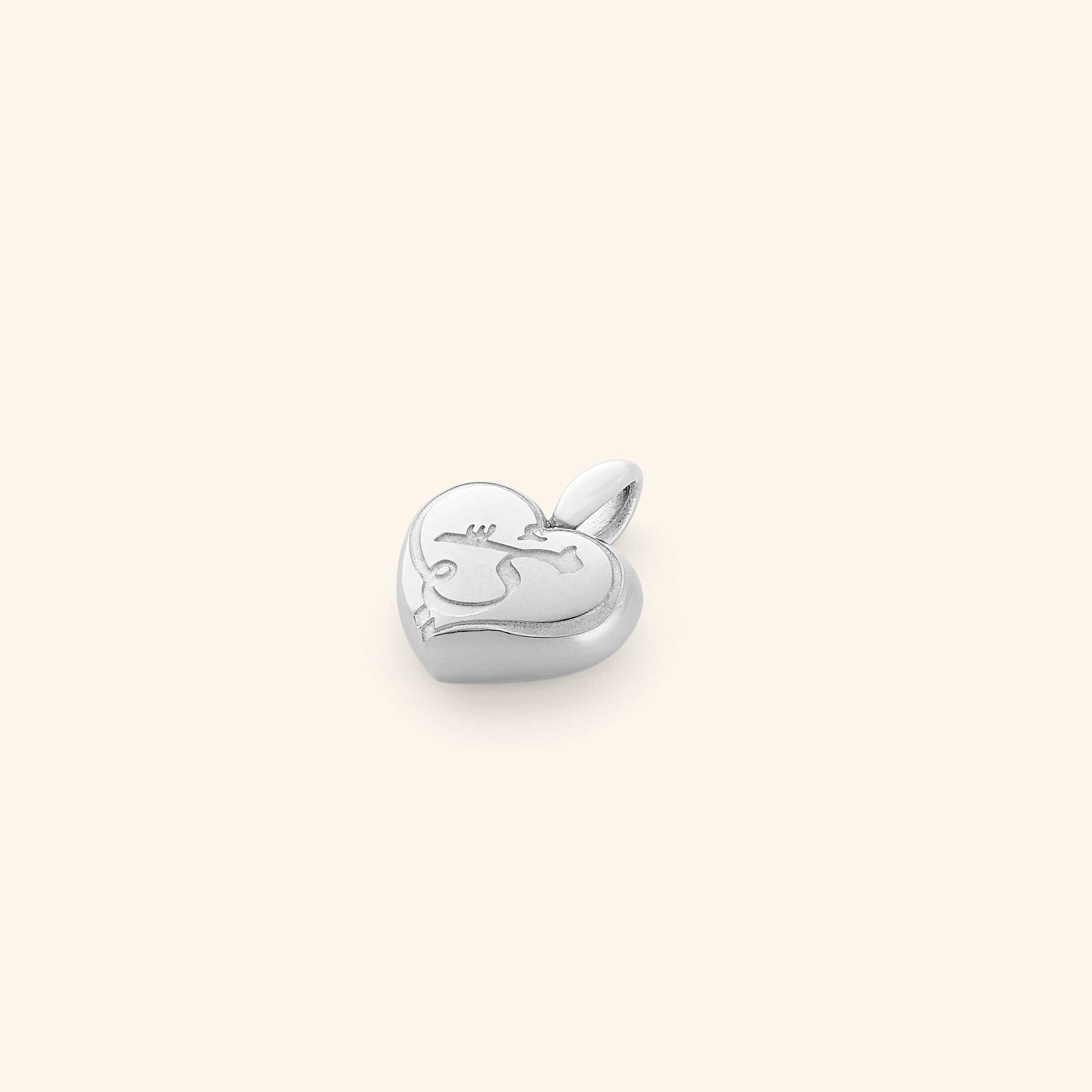 The Mama Heart Charm in a polished silver finish, displaying a puffed heart-shaped pendant with the word "mama" engraved in graceful script. The charm's sleek design and reflective surface highlight its refined craftsmanship.