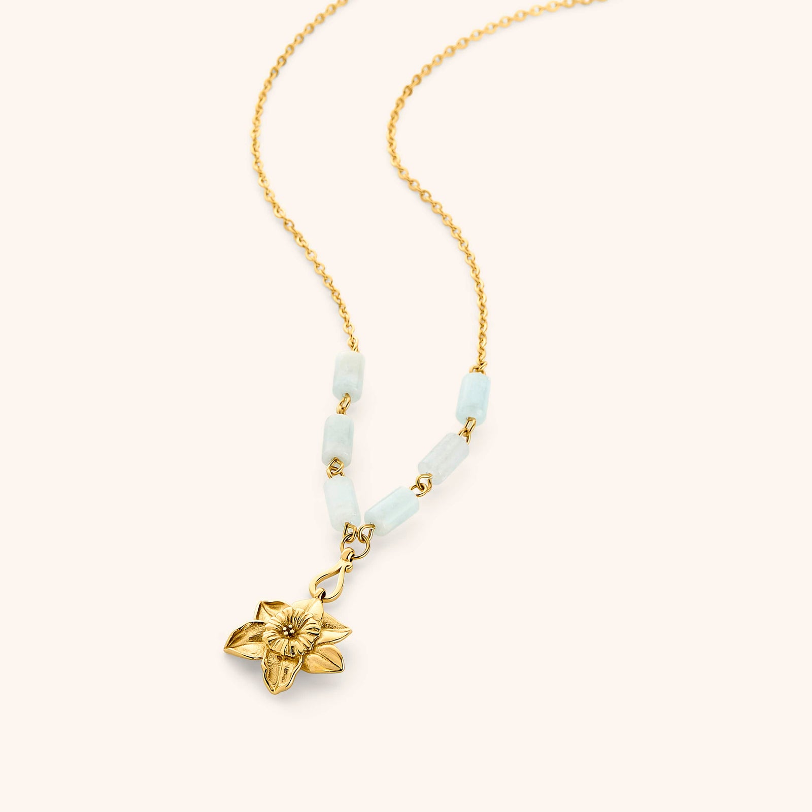 18k gold plated chain necklace with a detailed flower pendant and pale blue tube beads.