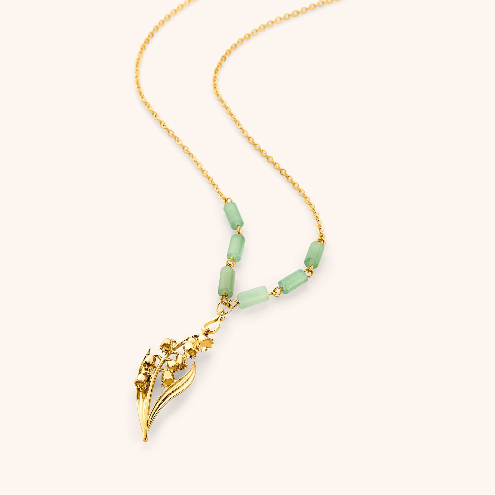 18k gold plated chain necklace with a detailed lily of the valley pendant and pale green tube beads.