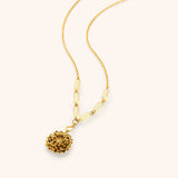 18k gold plated chain necklace with a chrysanthemum flower pendant, bright blue enamel center, and pale yellow tube beads.