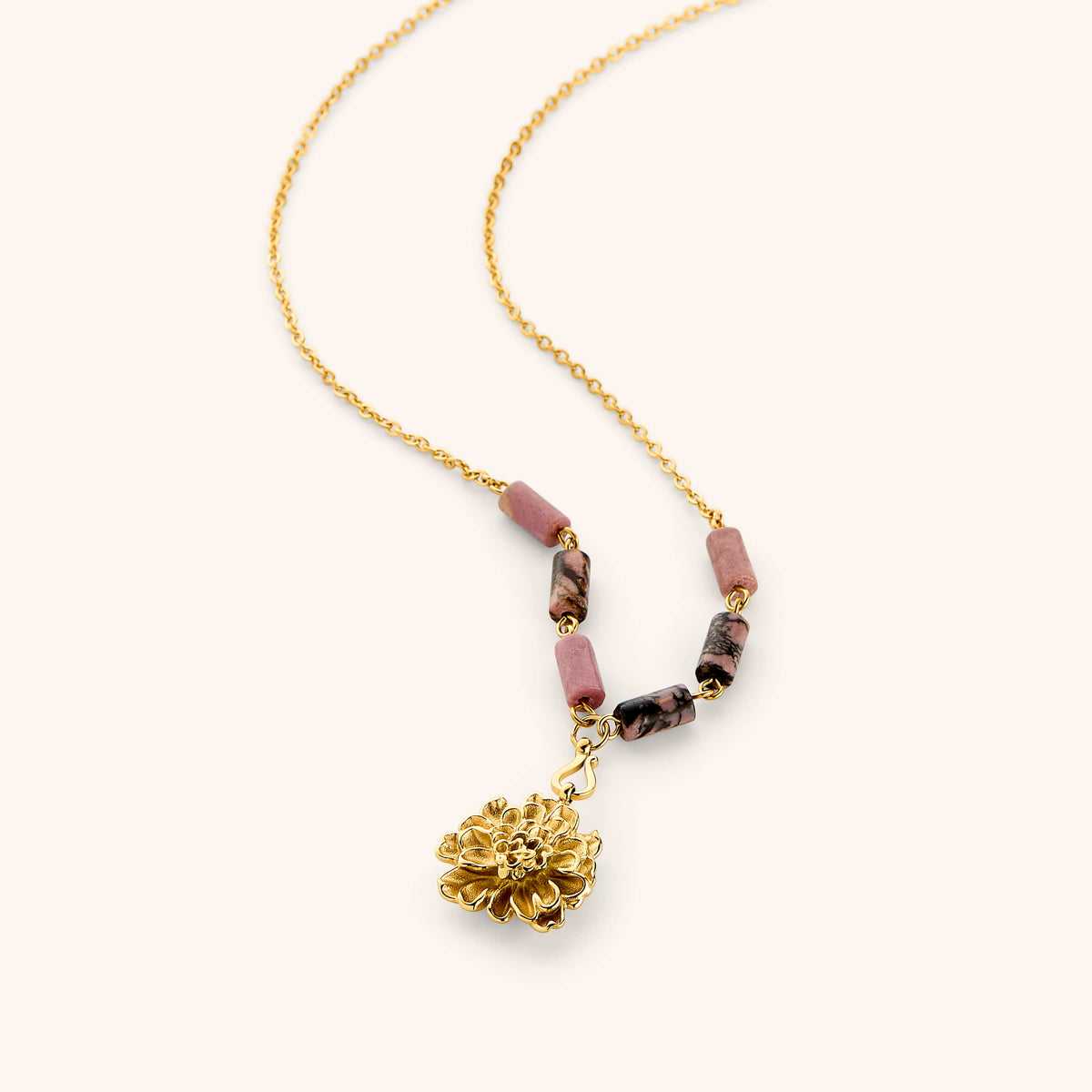 18k gold plated chain necklace with a textured gold flower pendant and pink and black marbled tube beads.
