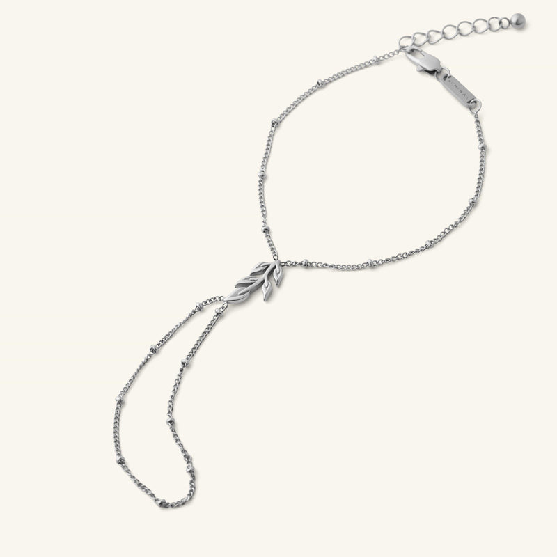 Palestinian Olive Branch Hand Chain in silver with a delicate chain and olive branch charm.