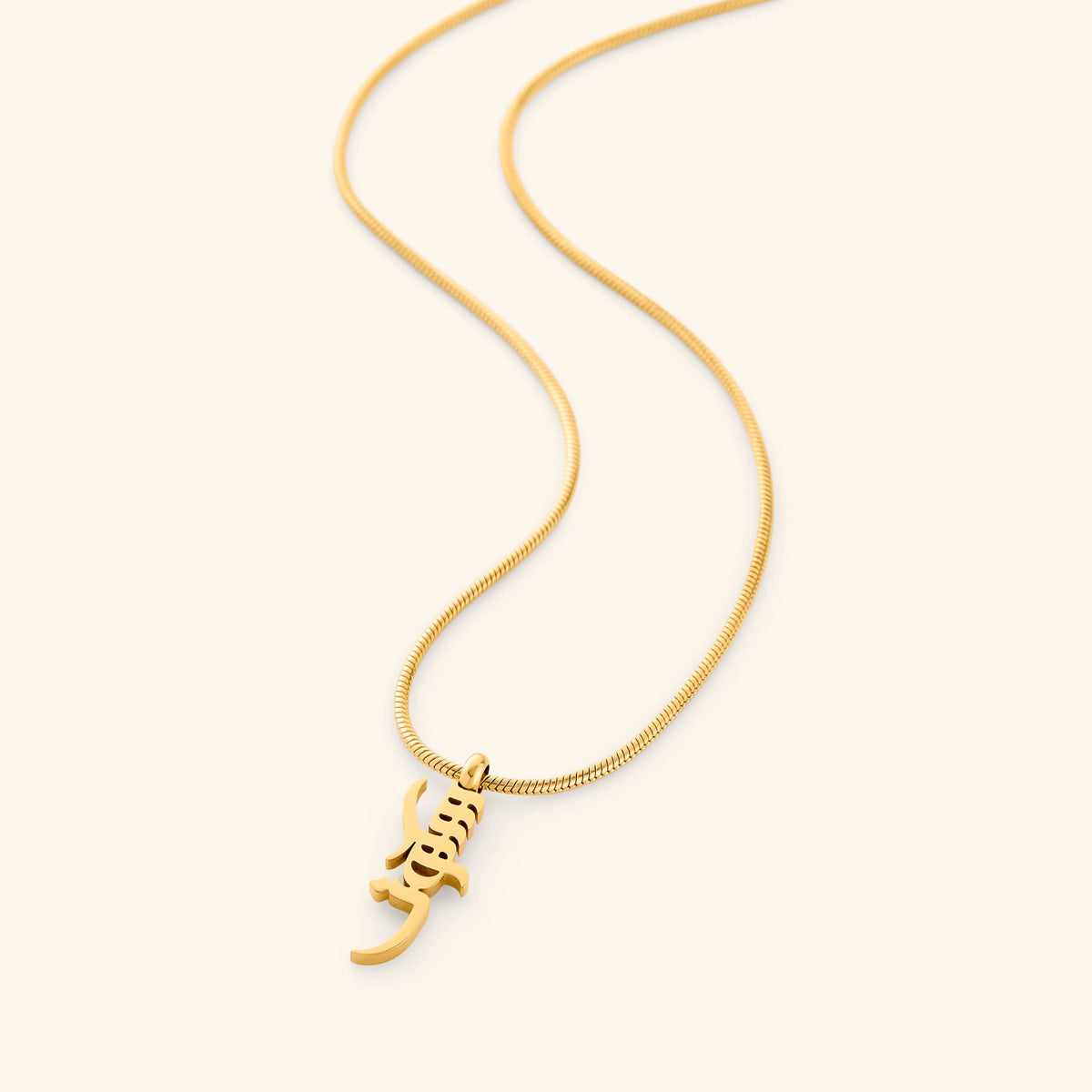 Gold Peace of Mind necklace with a pendant that reads "Sukoon" on a white background