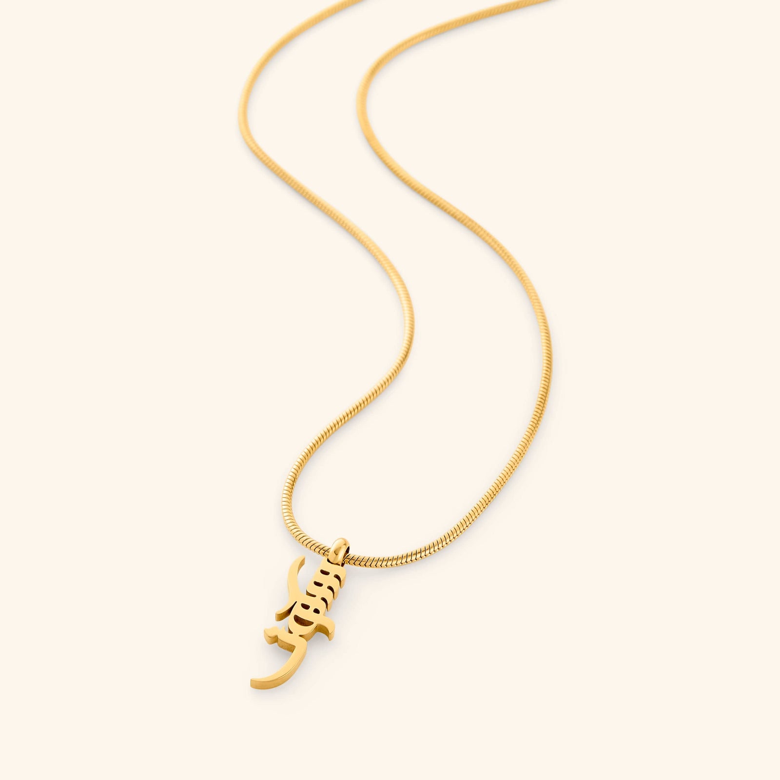 Gold Peace of Mind necklace with a pendant that reads "Sukoon" on a white background