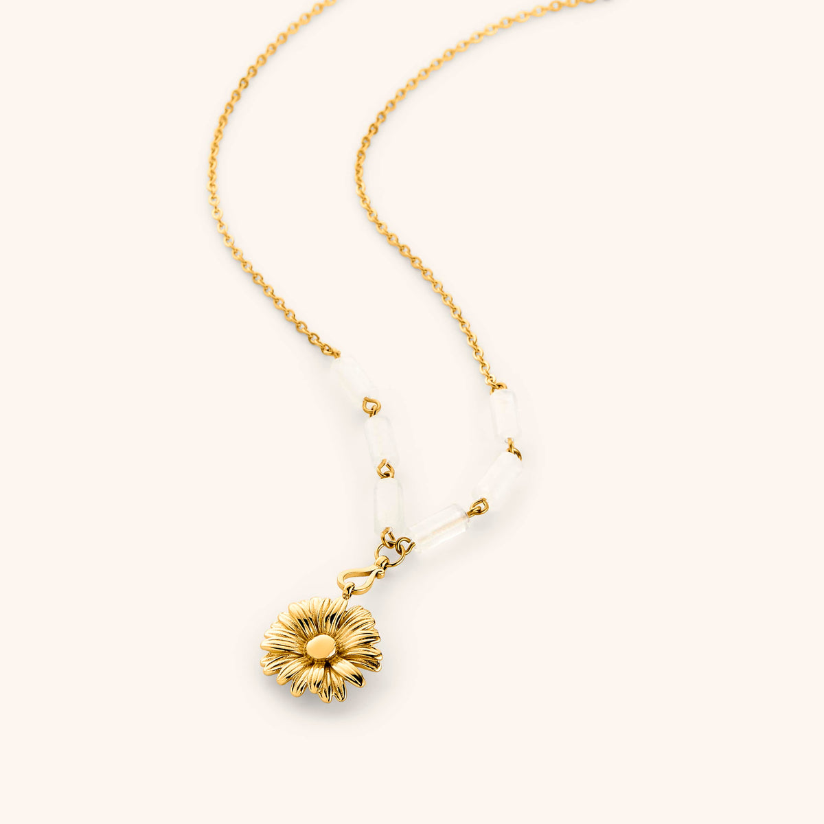 18k Gold chain necklace with a detailed daisy flower pendant and translucent white tube beads.