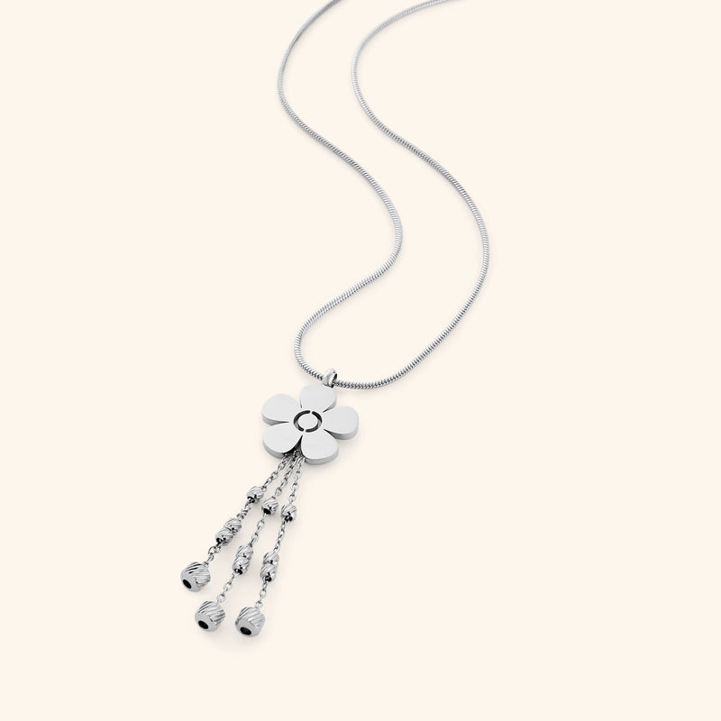 Close-up of the silver Raining Flower Necklace worn on the neck pimage_ styled with matching earrings pimage_ showing the flower pendant with bead-detailed chains.