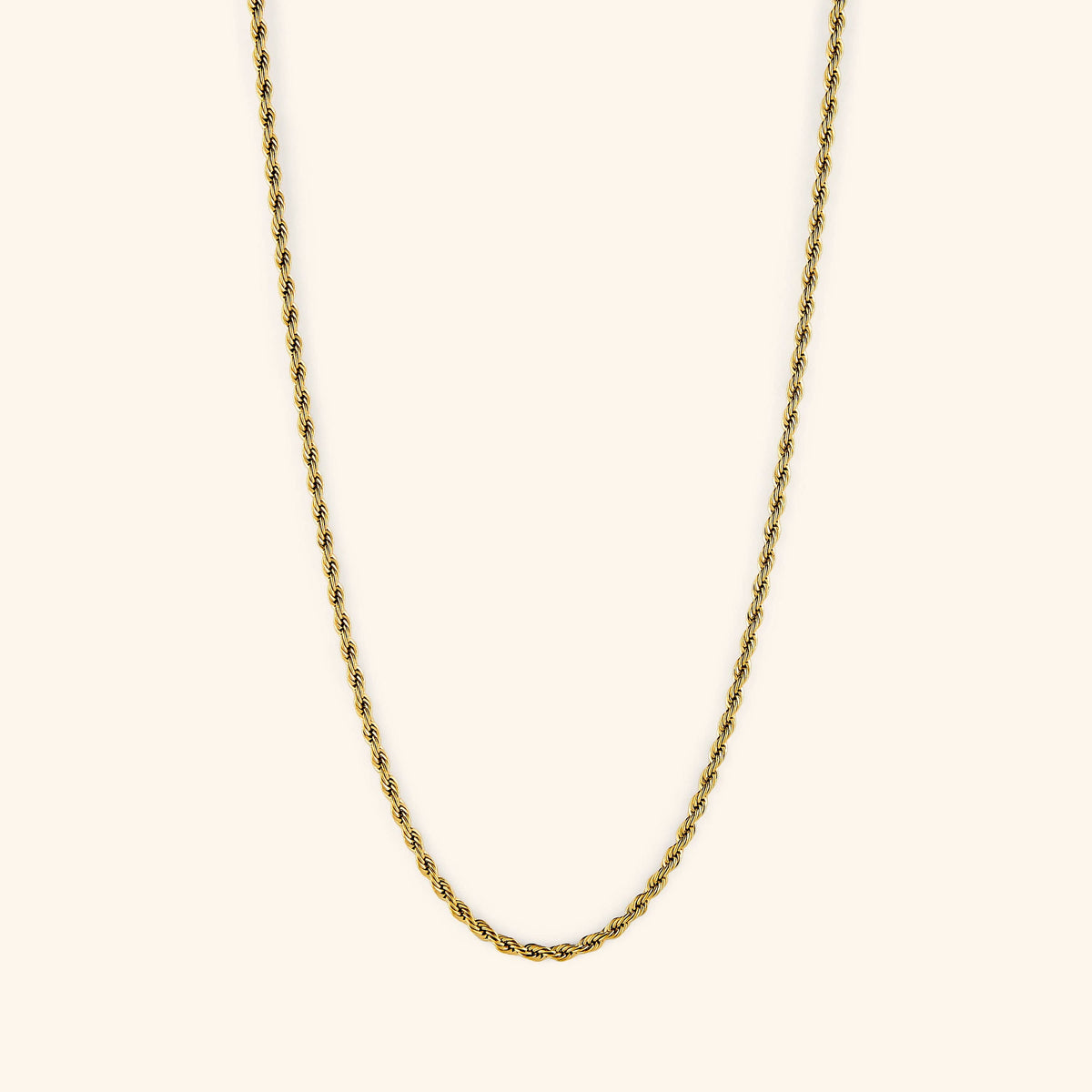 Gold rope chain necklace displayed on a light cream background