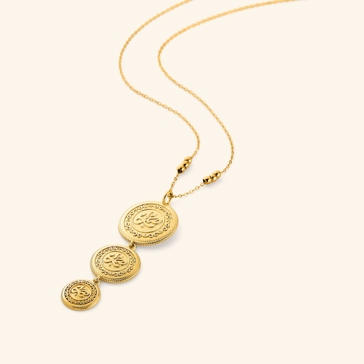 18k gold plated necklace that features three coins stacked and stamped with صبر (patience), hanging from a beaded chain, the coins are kept graduated in size, on a thin chain.