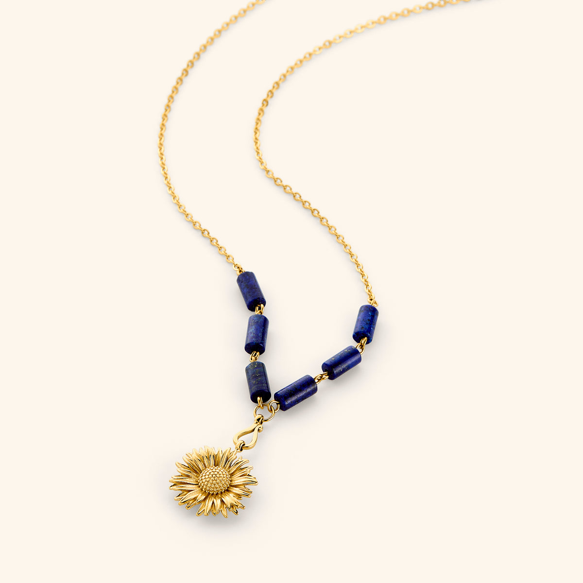 18k gold plated chain necklace with a detailed sunflower pendant and deep blue tube beads.