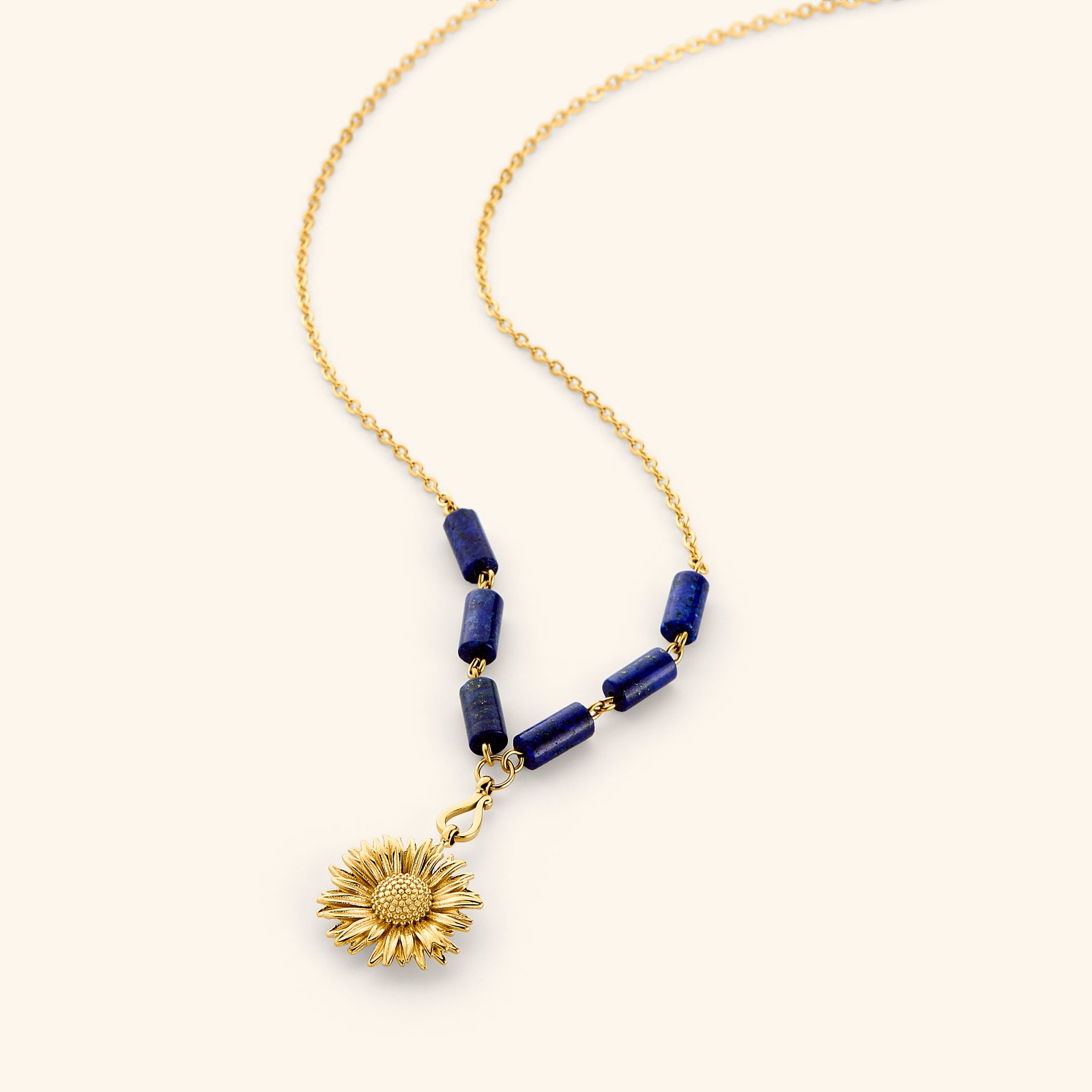 18k gold plated chain necklace with a detailed sunflower pendant and deep blue tube beads.