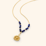 18k gold plated chain necklace with a detailed sunflower pendant and deep blue tube beads.