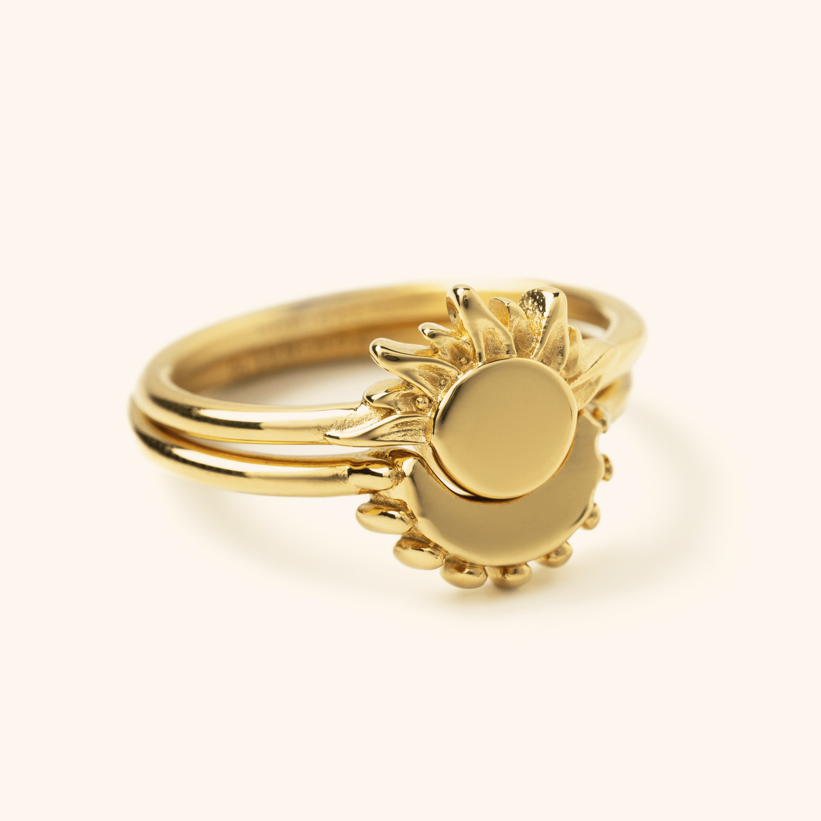 Gold sun ring stacked with a matching gold moon ring