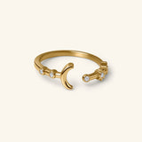 18k gold-plated Crescent Moon & Star Bezel Ring featuring an open band design with a crescent moon and star motif, detailed with round clear bezel-set crystals.