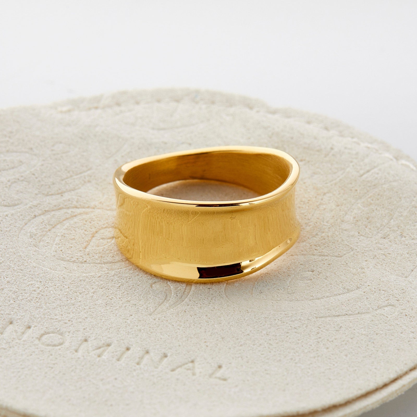 Gold Chunky Melt Ring displayed on a beige textured surface