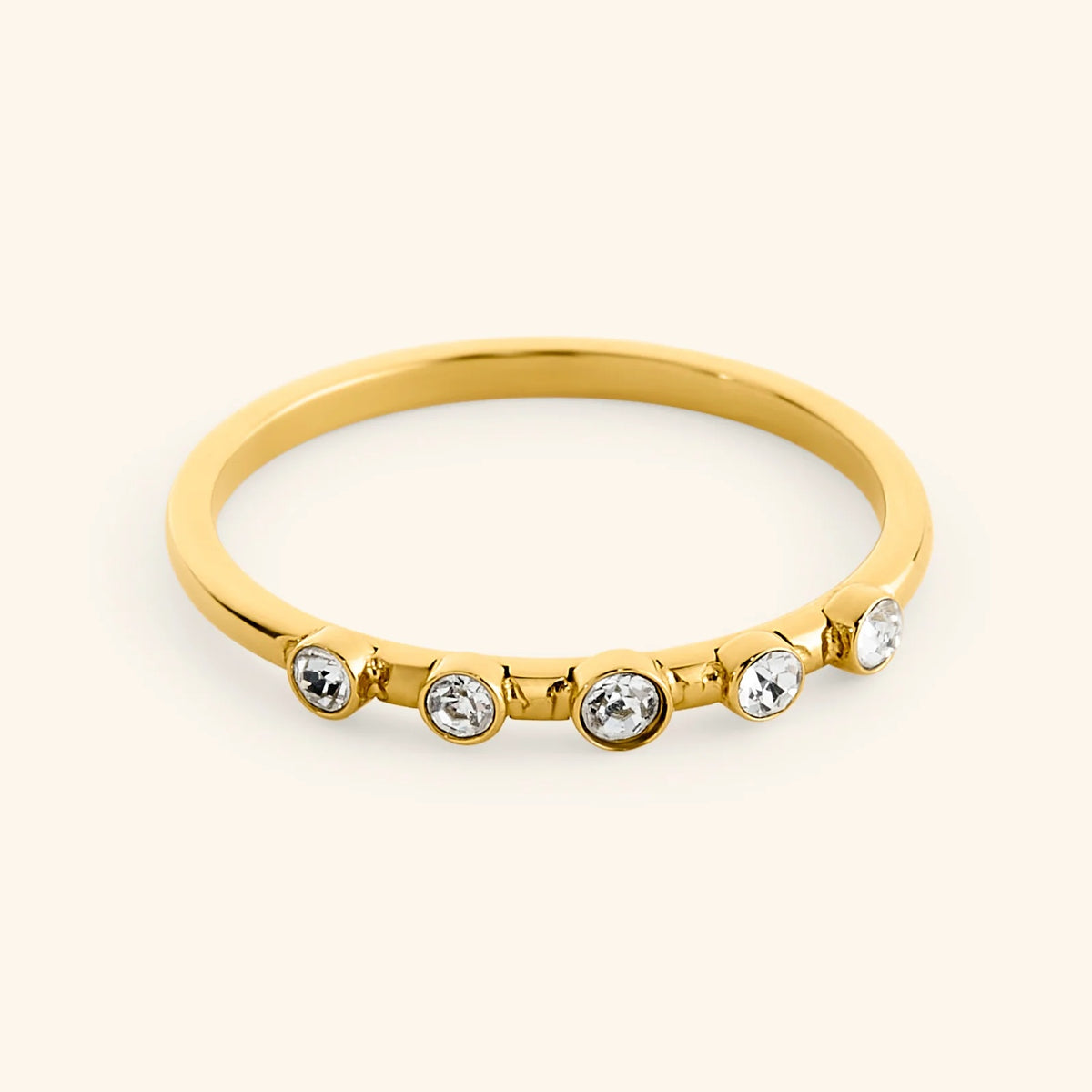 18k gold-plated Five-Stone Bezel Ring set with five round, bezel-set clear crystals across the top.