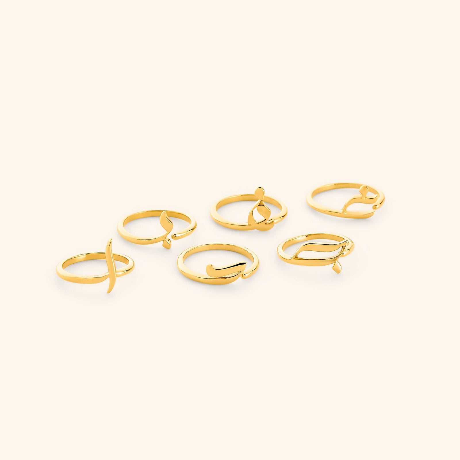 Set of gold Arabic Letter Wrap Rings featuring different letters.