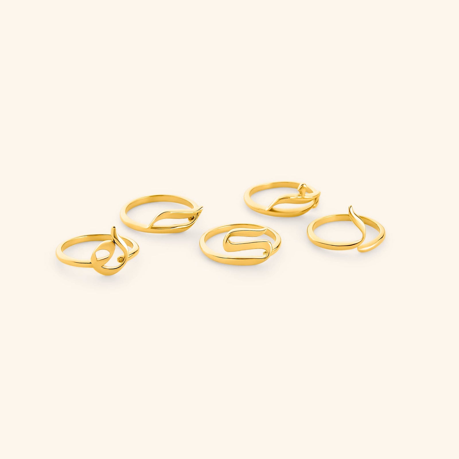 Set of gold Arabic Letter Wrap Rings featuring different letters.