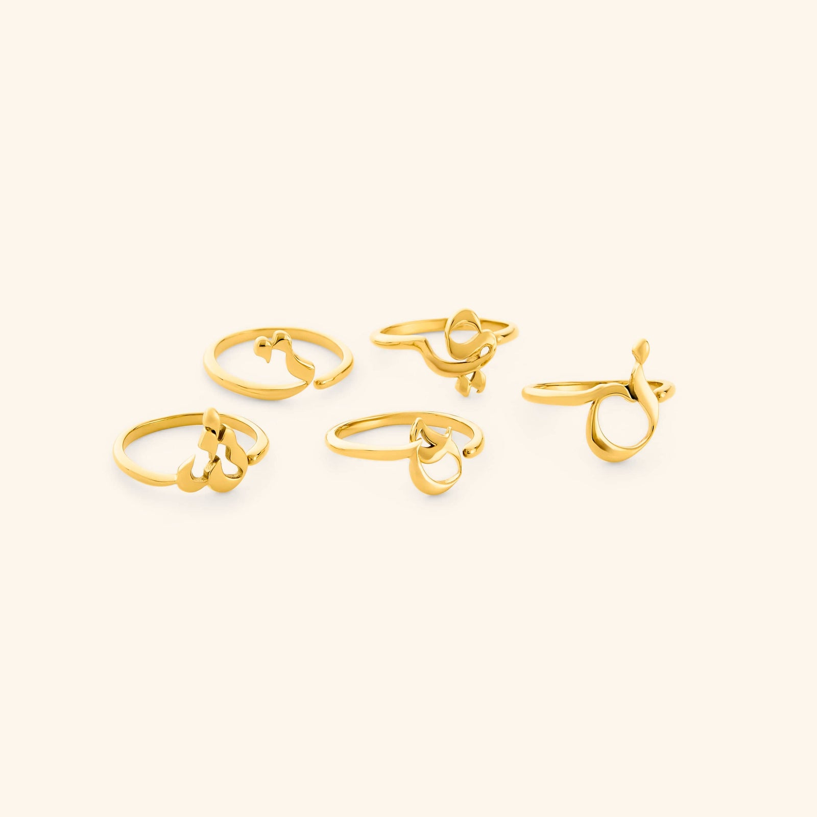 Set of gold Arabic Letter Wrap Rings featuring different letters.