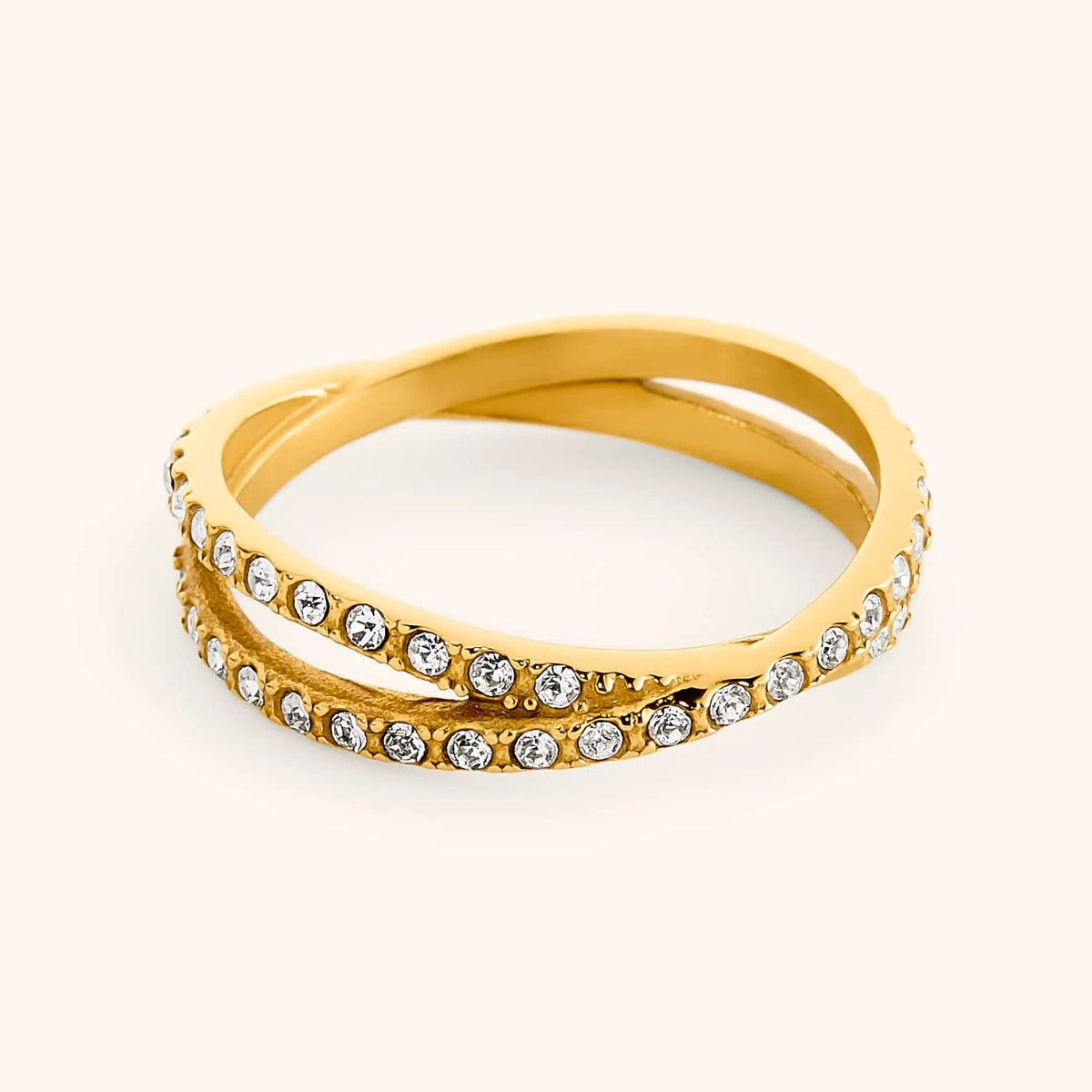 18k gold-plated Intertwined Bezel Ring featuring crisscrossing dual bands set with clear pavé crystals.