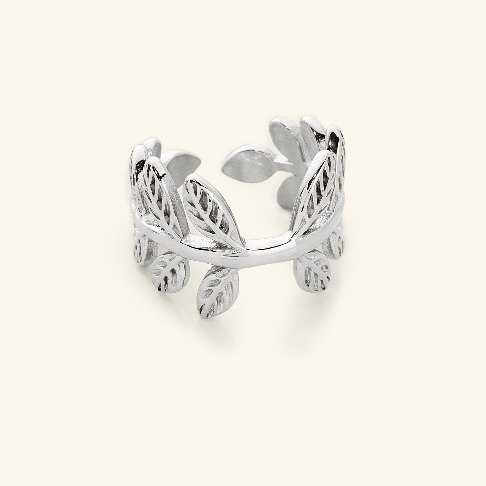 Close-up of a silver Olive Branch Ring with open wrap design, showcasing leaf engravings around the band.