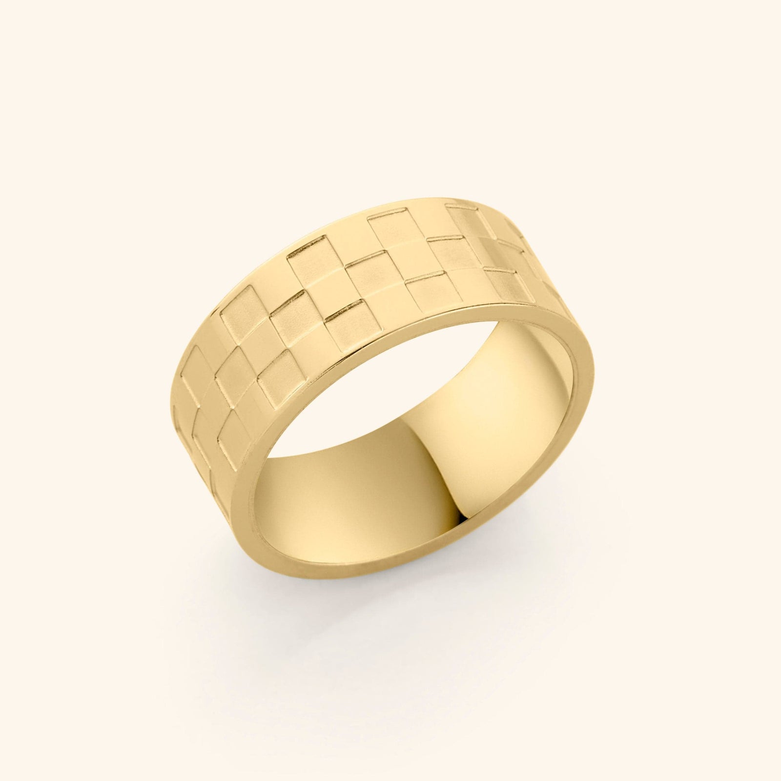 Gold Queen’s Ring with wide band featuring a raised square checkered pattern across the surface.