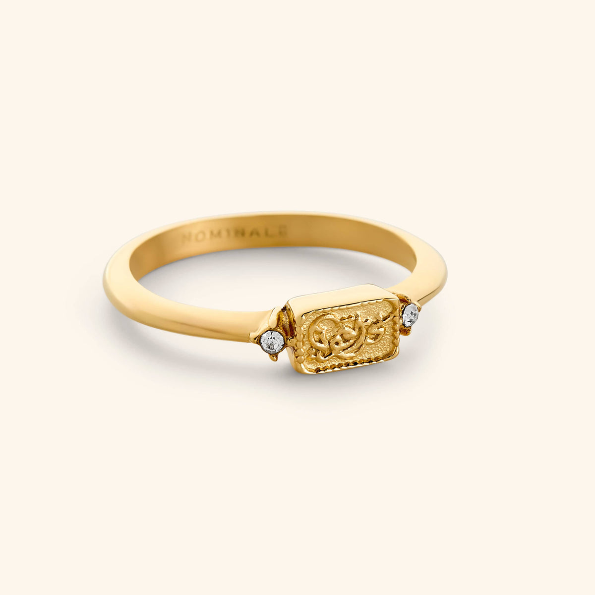 18K Gold plated minimal band ring with a rectangular plate design that reads "we are strong" in Arabic calligraphy.