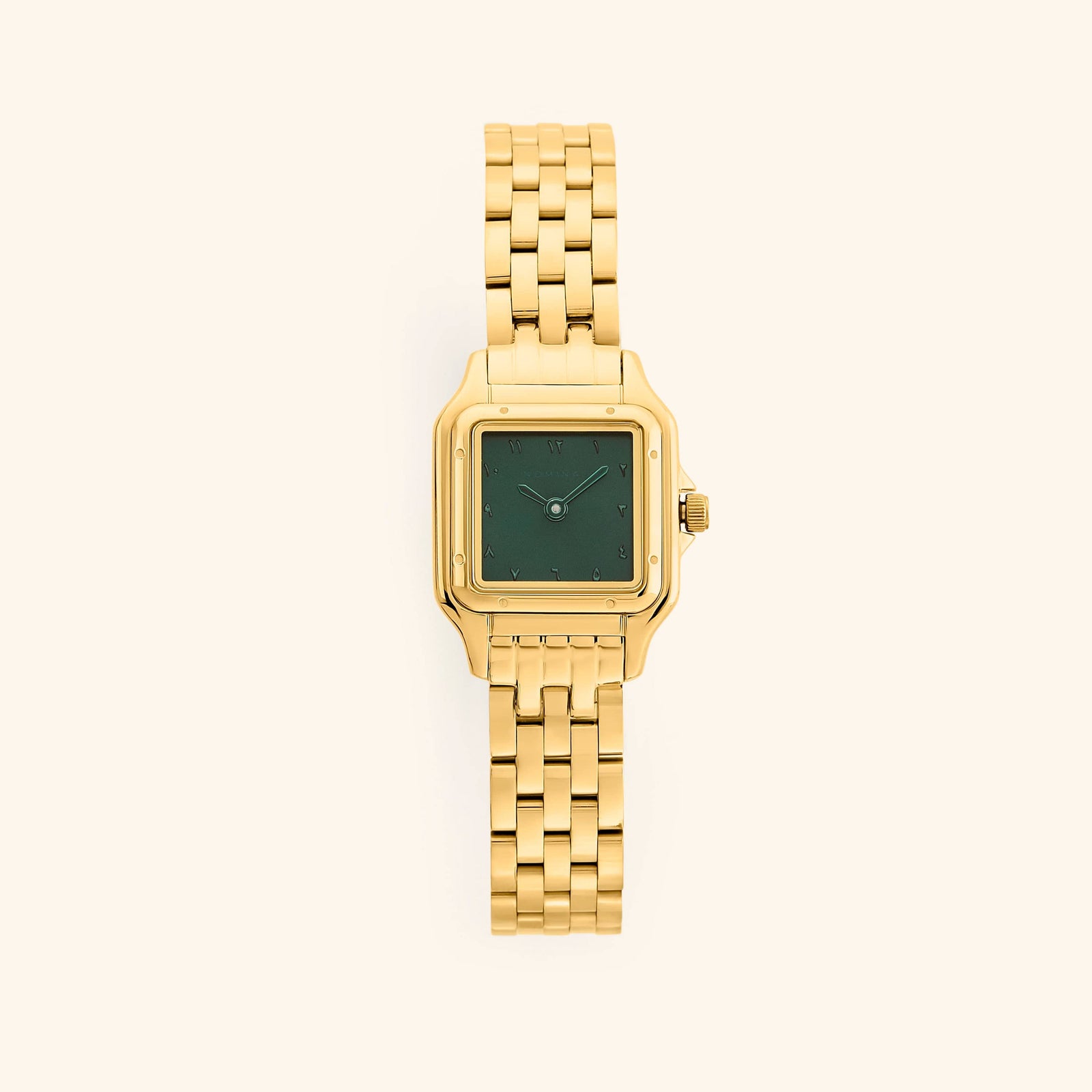 An analog watch that features gold and emerald combination with a rectangular face and a monochromatic face design.