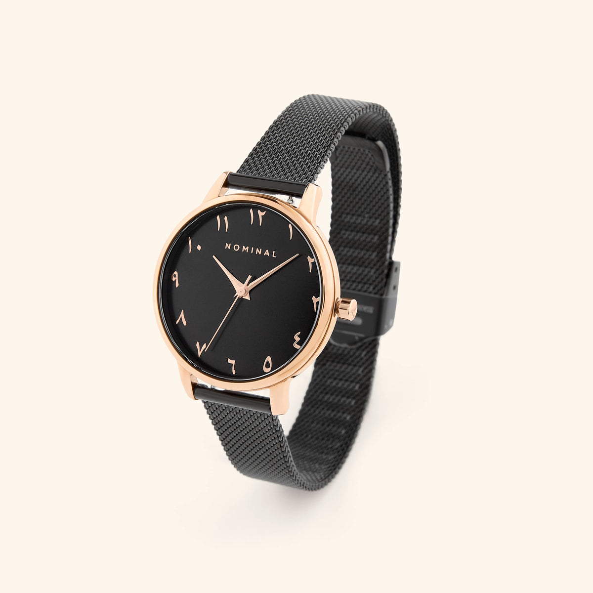 Black mesh watch with black background and rose gold details, with minimalist Arabic numerals against a neutral background. 