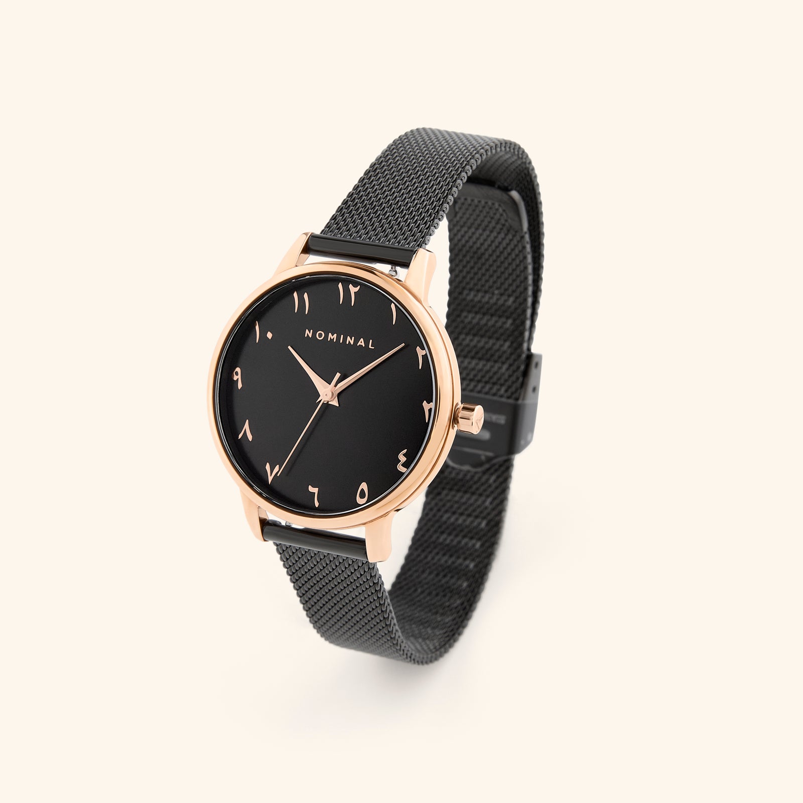 Black mesh watch with black background and rose gold details, with minimalist Arabic numerals against a neutral background. 