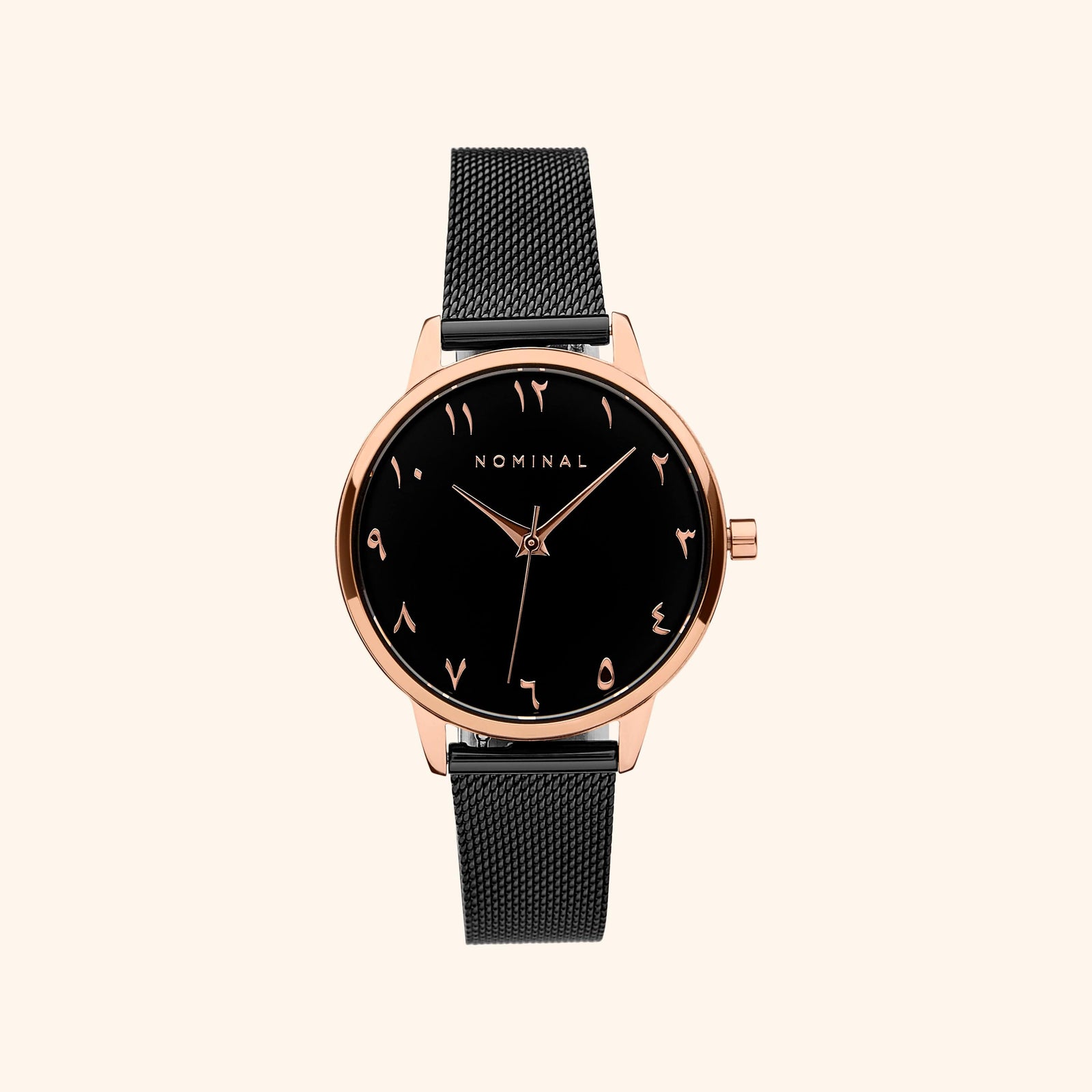 Black mesh watch with black background and rose gold details, with minimalist Arabic numerals against a neutral background. 