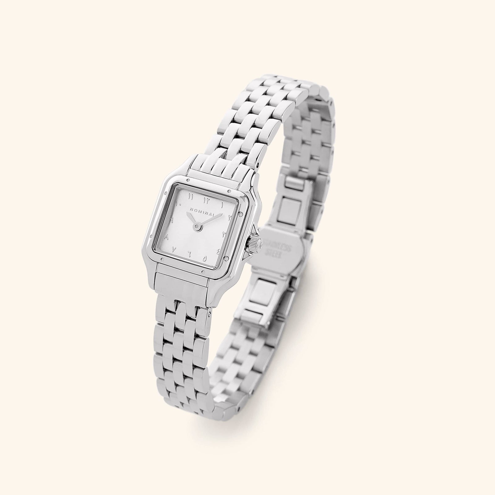 A silver analog watch that features a rectangular face and a monochromatic face design.