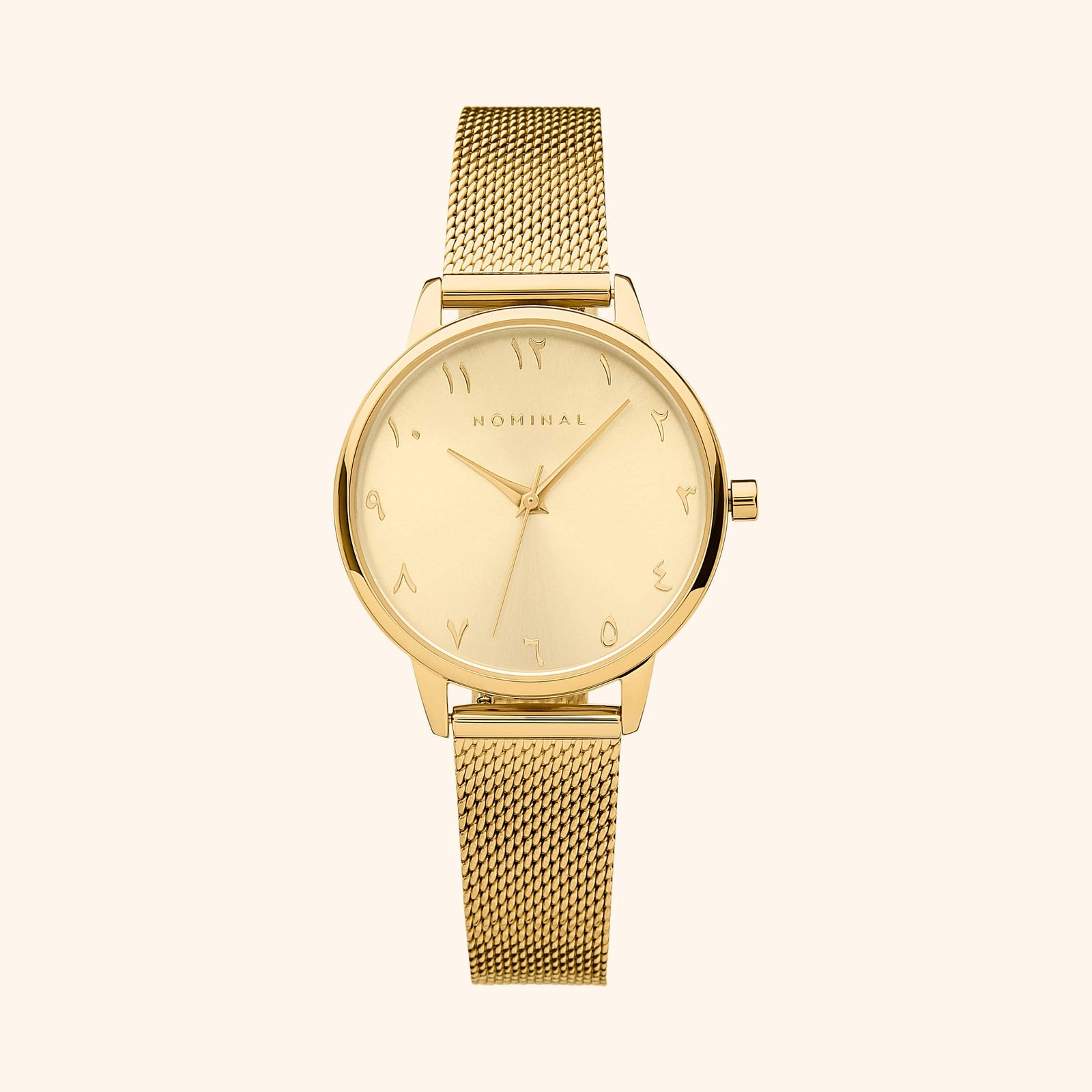 Gold mesh strap watch with minimalist Arabic numerals, displayed against a neutral background.
