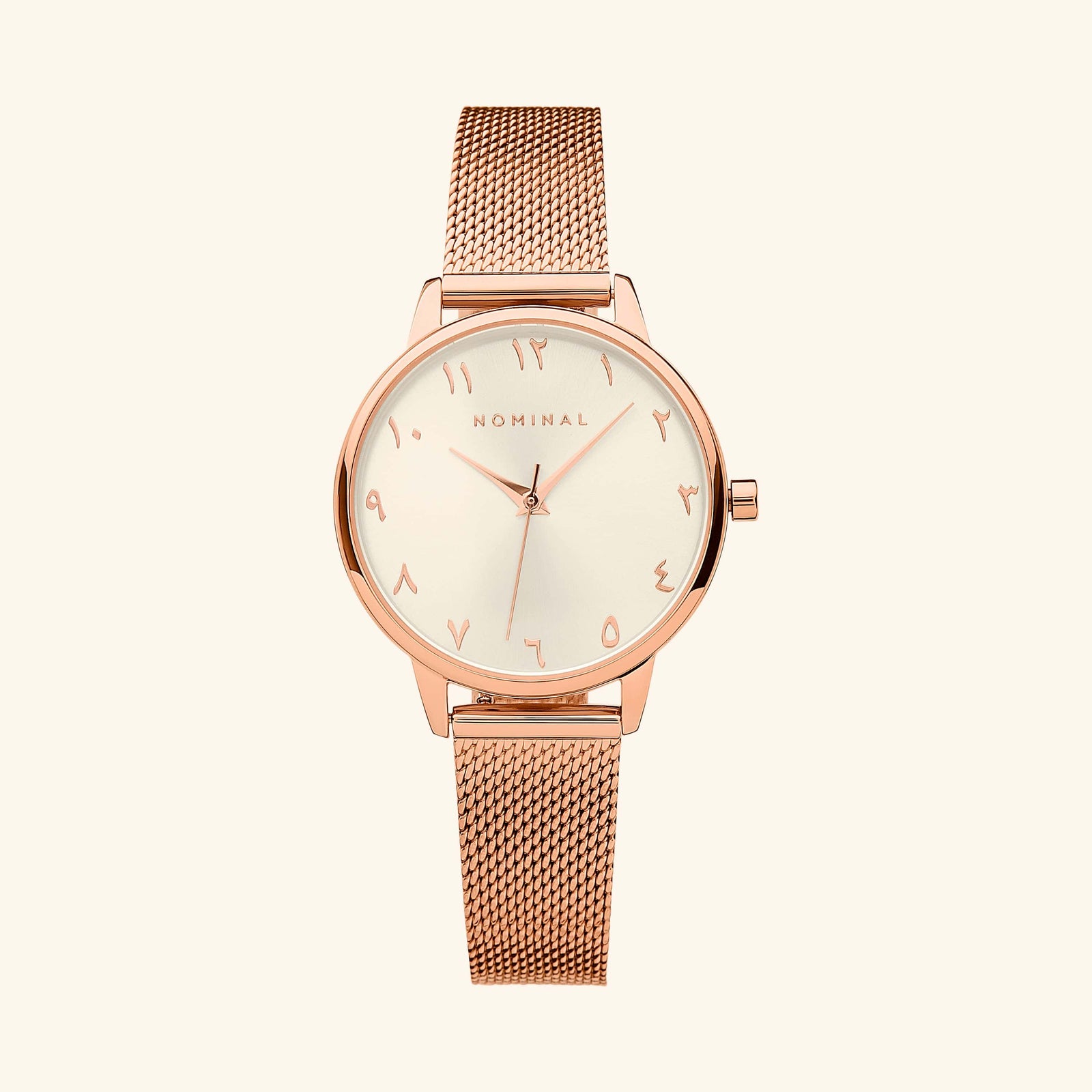 Rose gold mesh strap watch with minimalist Arabic numerals, displayed against a neutral background.