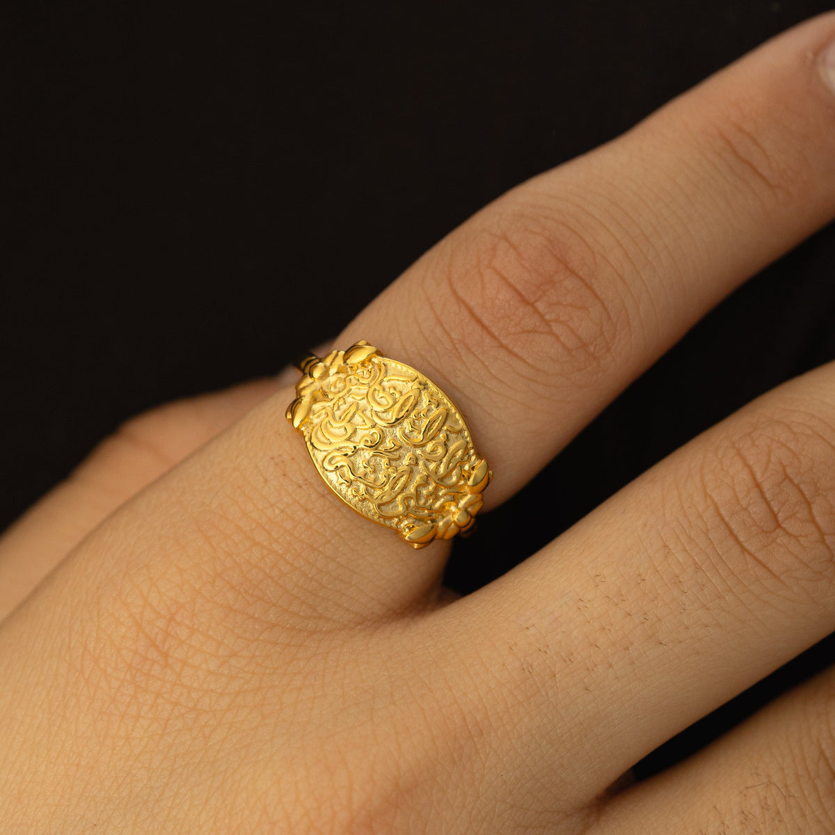 Close up photo of the gold "Walk to Me, and I'll run to you" Medallion Ring as worn by the model.