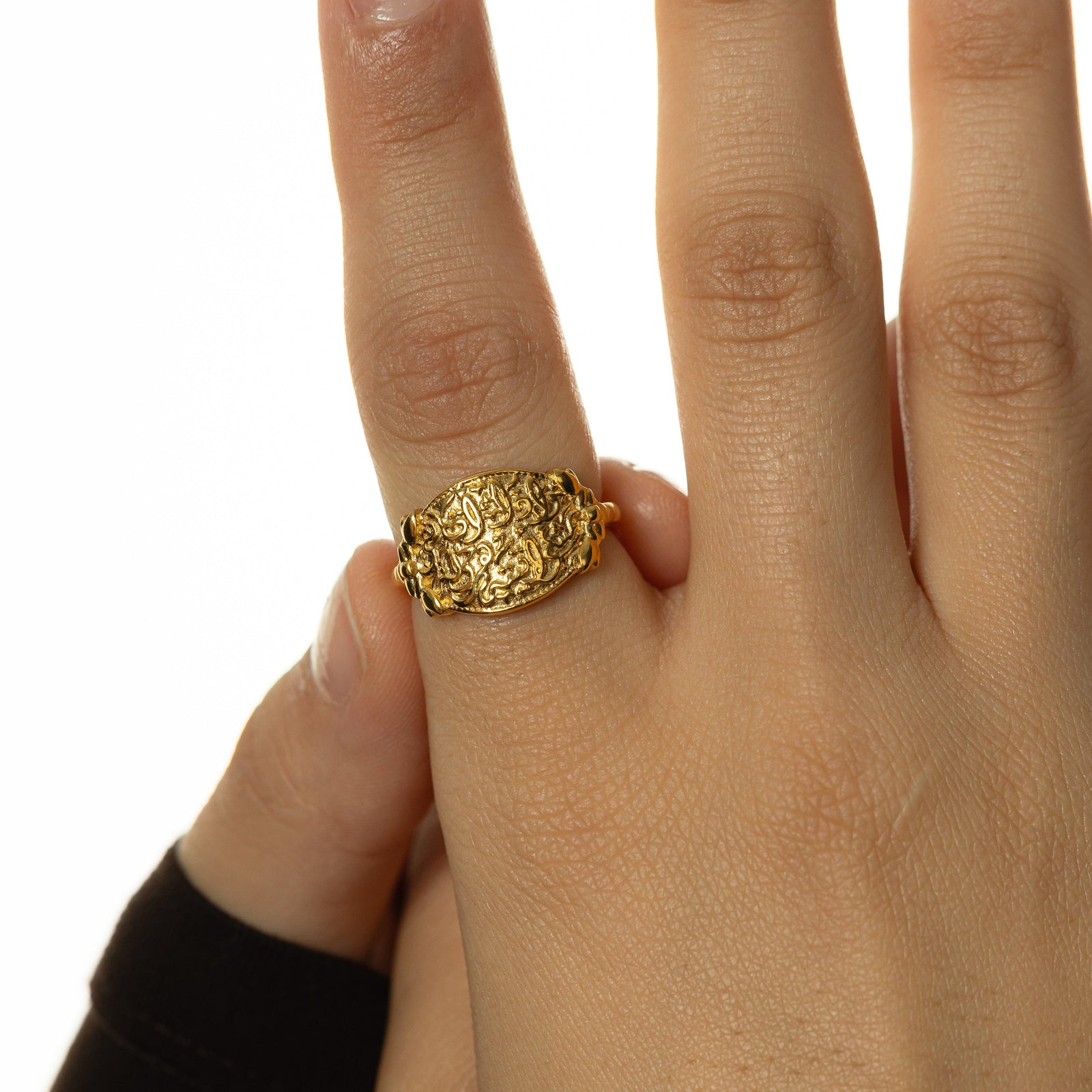 Close up photo of the "Walk to Me, and I'll run to you" Medallion Ring as worn by the model.